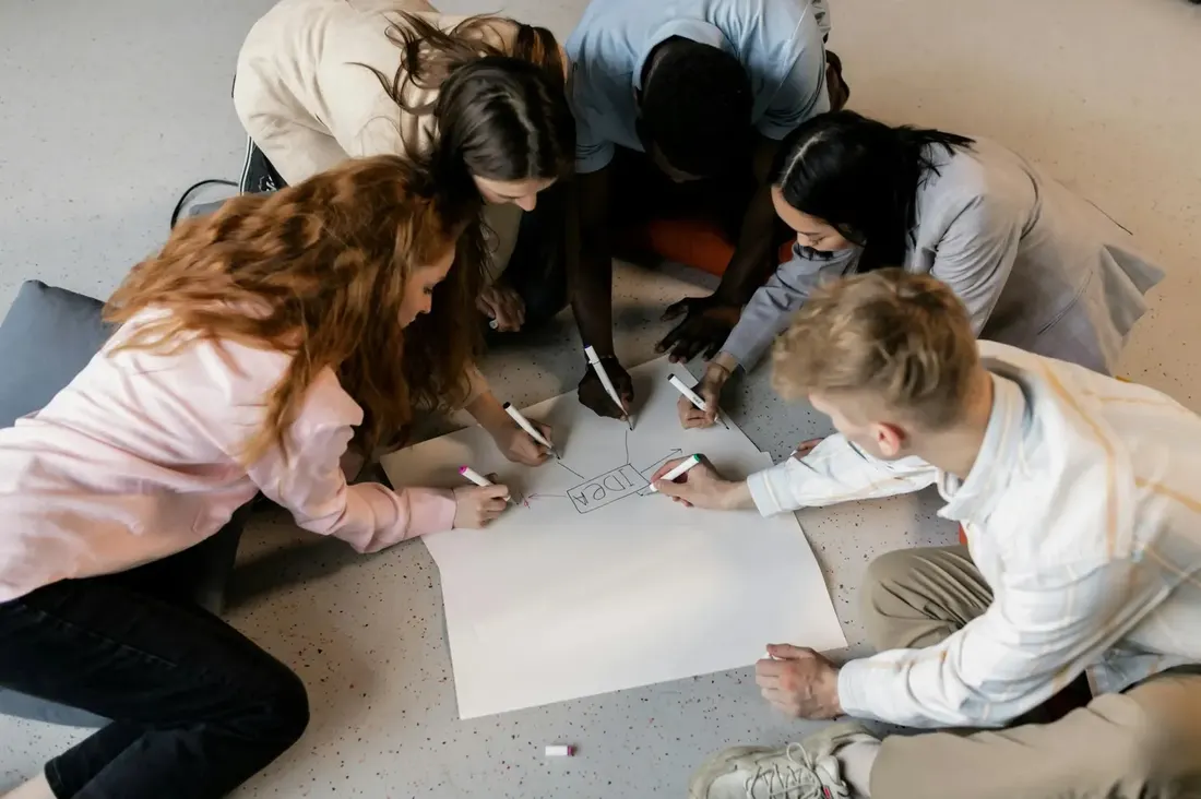 Young people collaborating together around a shared project